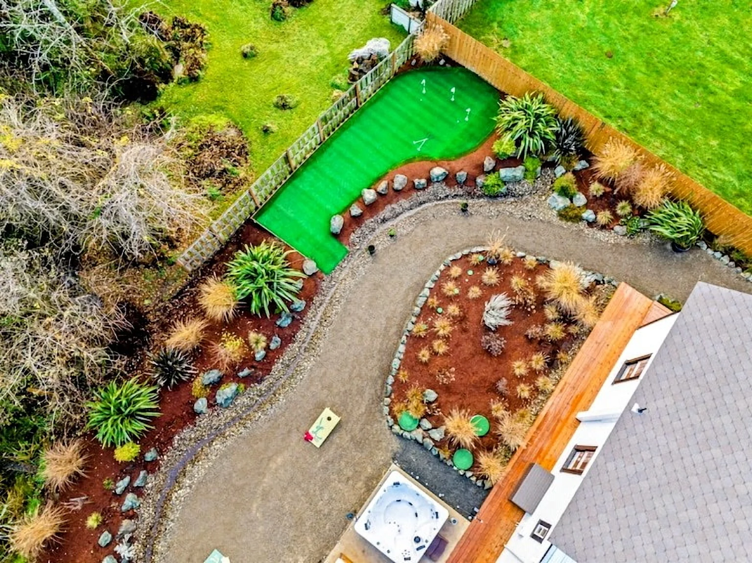 Aerial view of a finished backyard build with putting green in Bandon