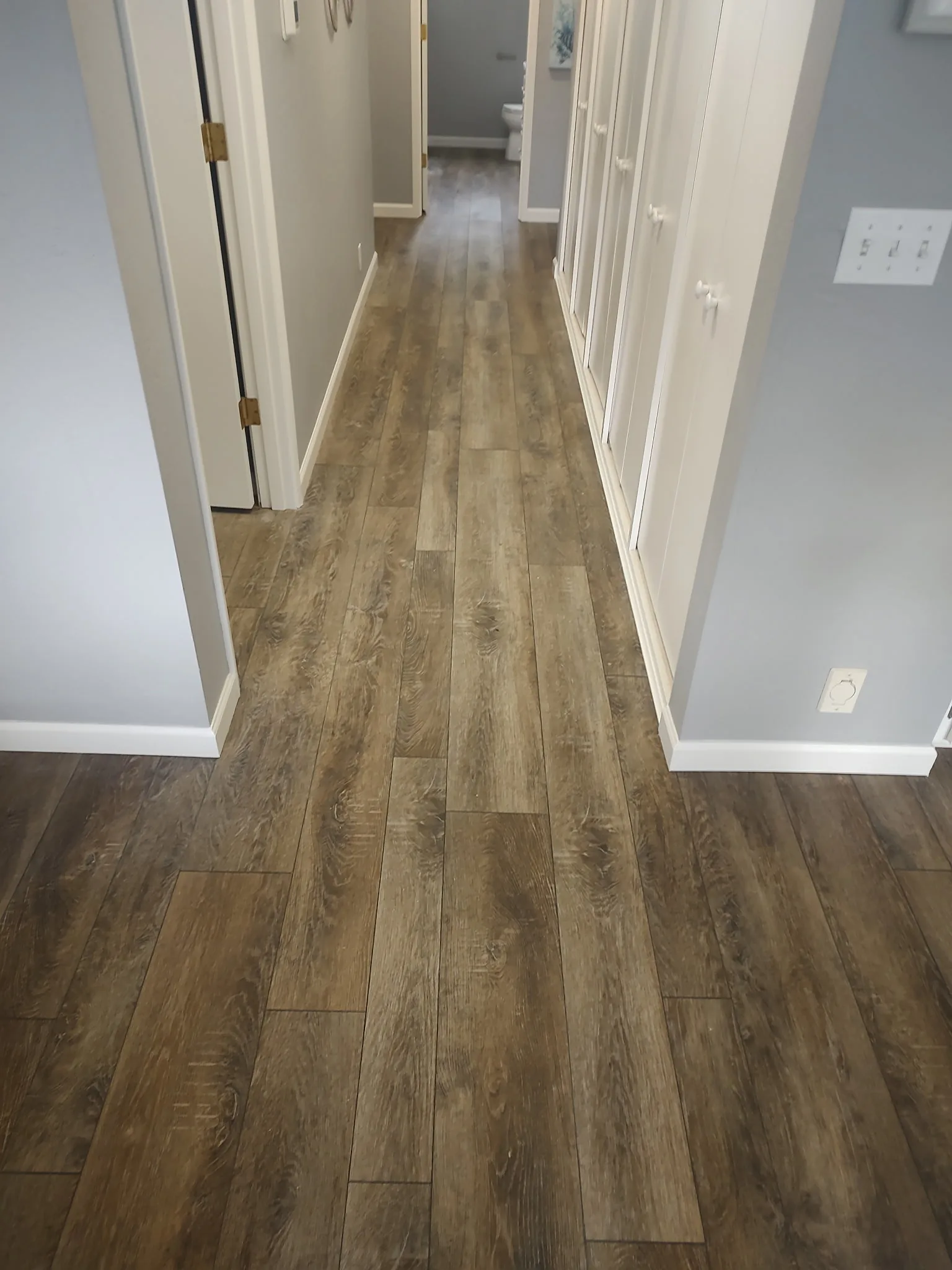 Hallway with new wood-look plank flooring installed by SeaBreeze