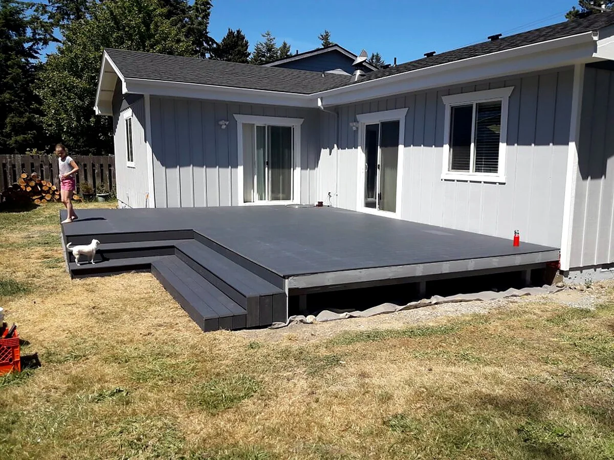 Full finished deck wrapping a coastal home, built by SeaBreeze