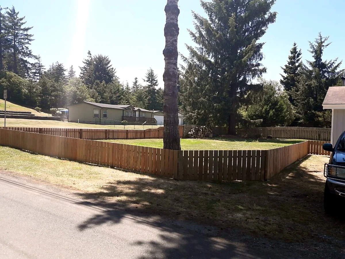 Wood fence line built to take coastal wind by SeaBreeze