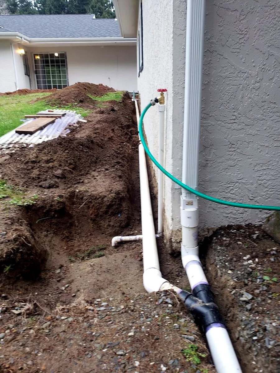 Downspout tied into an underground drainage line by SeaBreeze