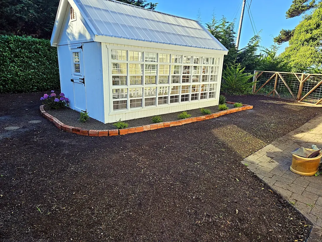 Freshly cleaned and gravelled grounds with new edging around a garden building, property care by SeaBreeze